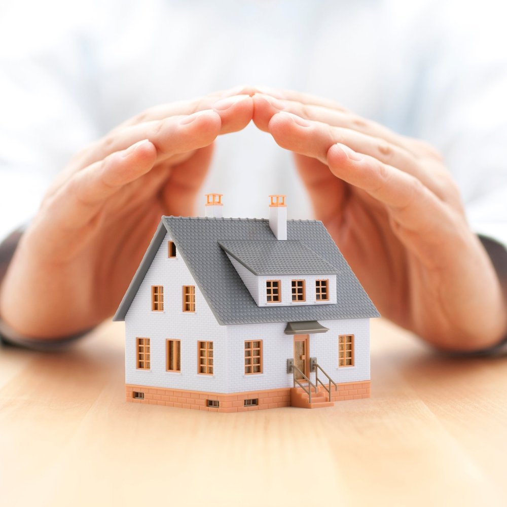 Protecting you home Home shielded by two hands