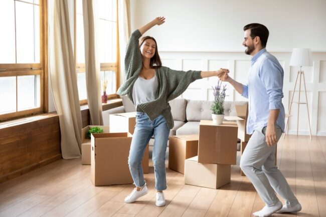 Happy,Young,Wife,And,Husband,Dancing,In,Modern,Living,Room