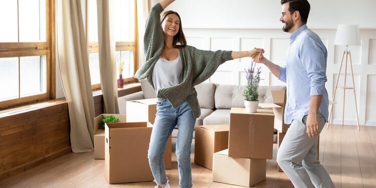 Happy,Young,Wife,And,Husband,Dancing,In,Modern,Living,Room