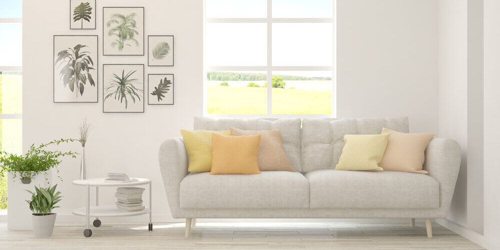 White,Living,Room,With,Sofa,And,Summer,Landscape,In,Window.