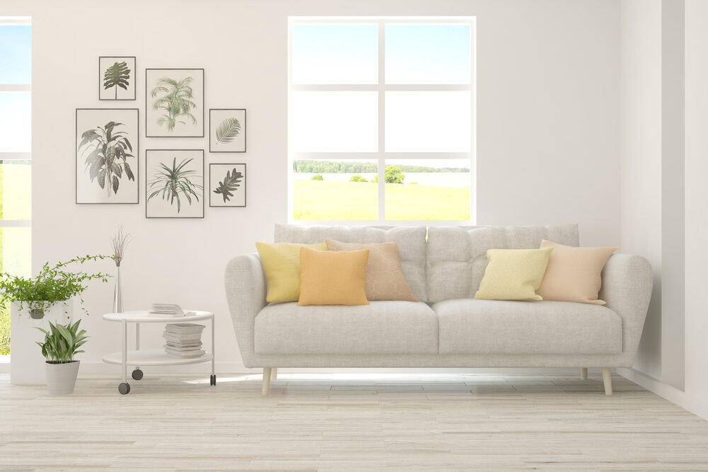 White,Living,Room,With,Sofa,And,Summer,Landscape,In,Window.